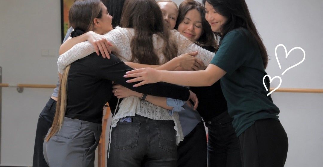 A group of volunteers in a warm group hug
